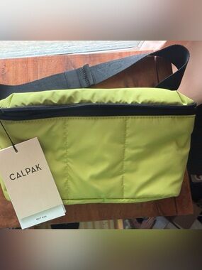 NWT CALPAK kiwi Green Sling Belt Bag with Black Strap